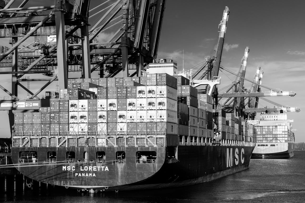 creative-01 Shipping containers and cranes at Hamburg port showcasing global trade.