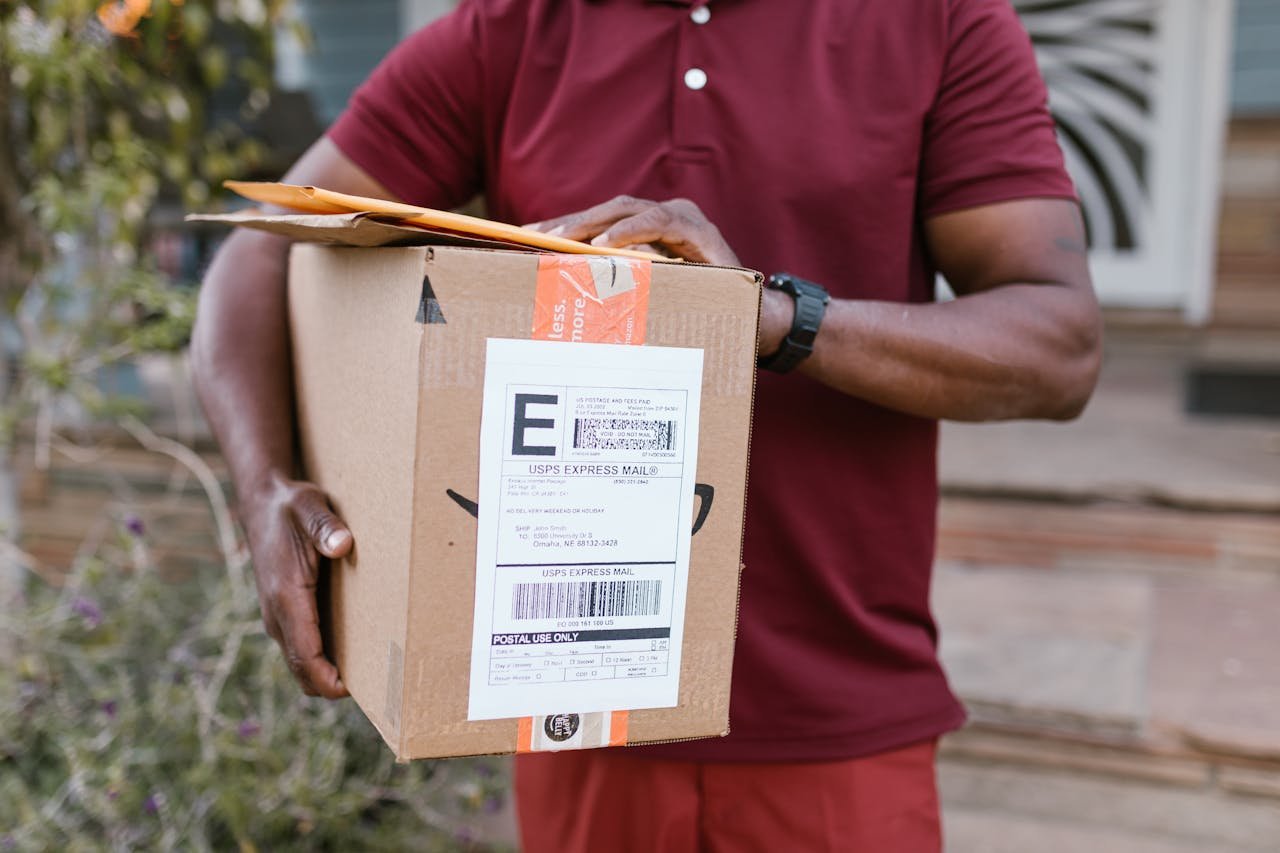 digital Close-up of a courier delivering a parcel with USPS express mail label outdoors.